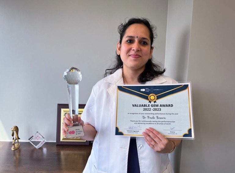 Dr. Prachi Benara holding the Valuable Gem Award trophy and certificate